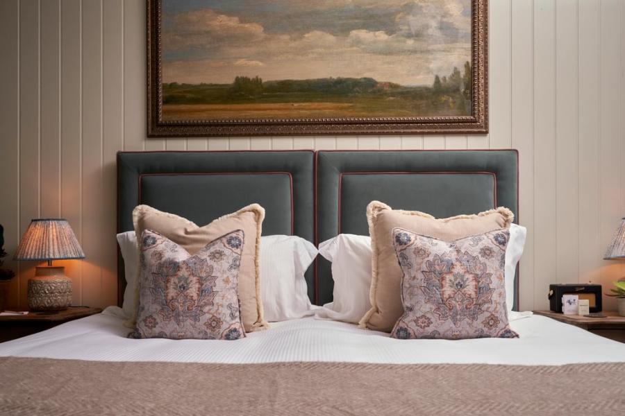 Cotswold Stay - Wonderful Winchcombe A painting of English countryside hangs above a large bed with decorative cushions